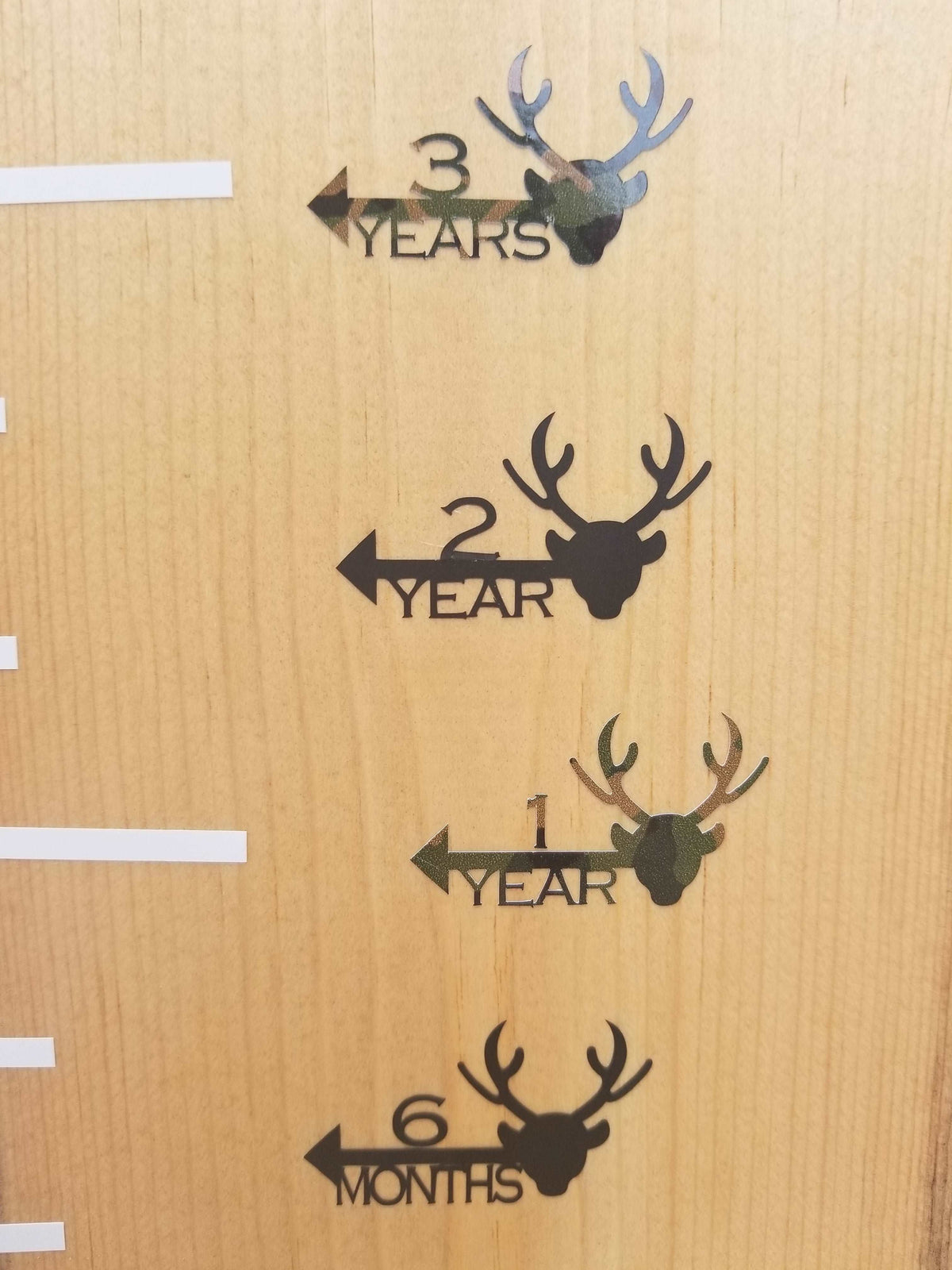 A wooden growth chart with Deer Height Marking Arrows from Little Prairie Craft Co.