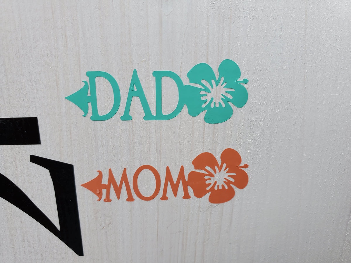 A sign with the words "dad" and "mom" on it, called the Hibiscus Parent Height Markers by Little Prairie Craft Co.