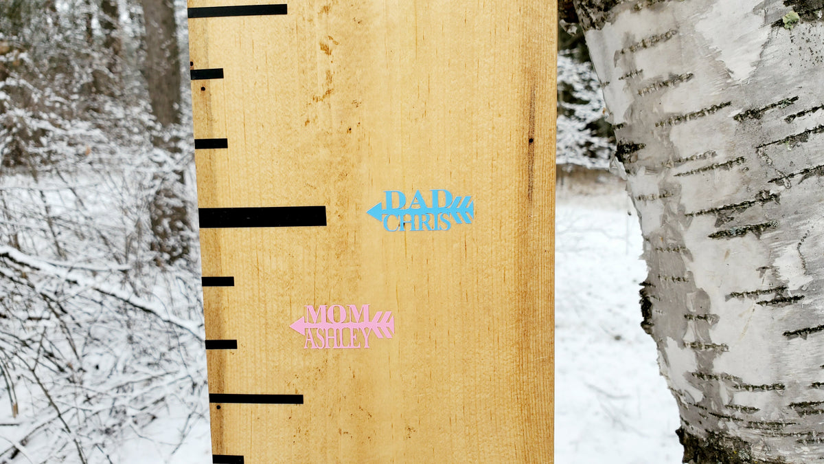 A Little Prairie Craft Co. wooden ruler with a pink and blue sticker on it.