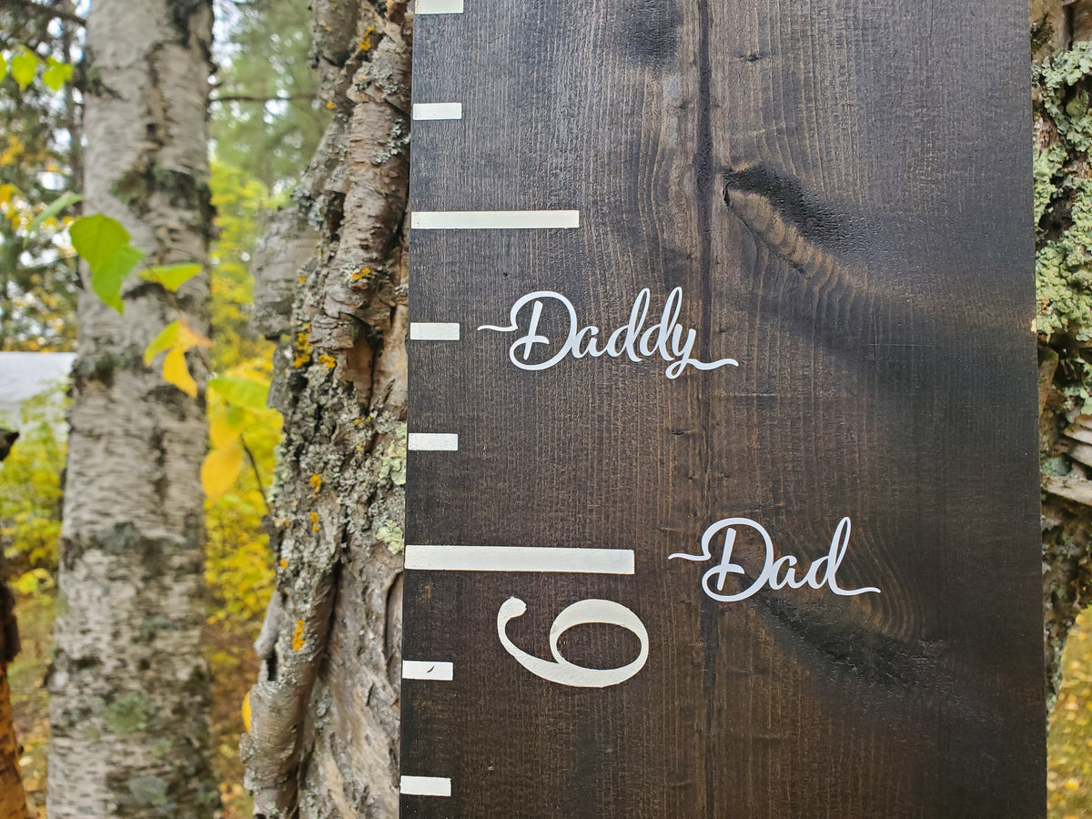 A Little Prairie Craft Co. wooden growth chart with the Written Words Parent Height Markers on it.