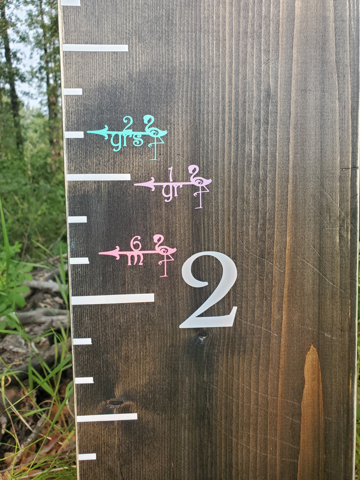 A Flamingo Height Marking Arrows with numbers on it made by Little Prairie Craft Co.