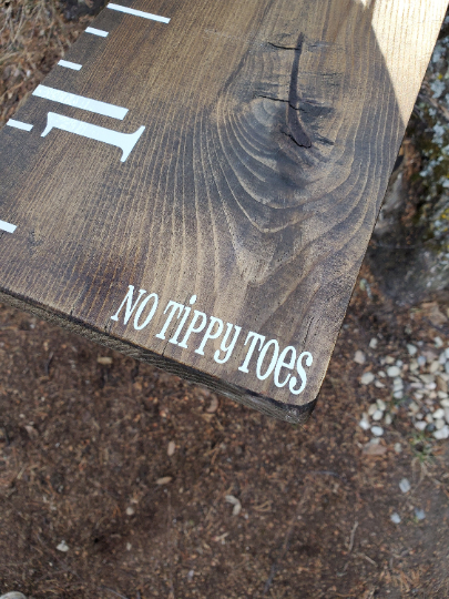 A wooden ruler with the words No Tippy Toes ~Growth Chart Sticker by Little Prairie Craft Co. on it.