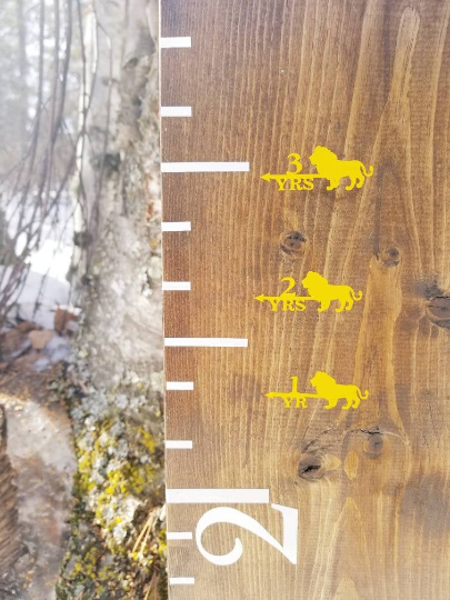 A Lion Height Marking Arrows wooden ruler with a number of horses on it from Little Prairie Craft Co.