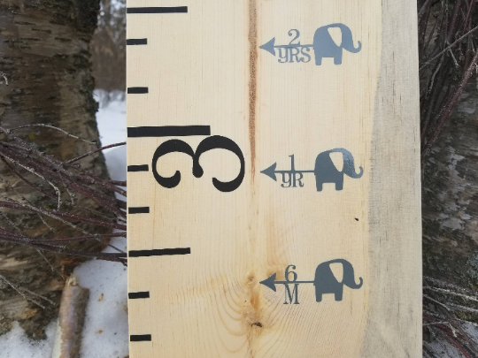 A wooden Elephant Height Marking Arrows growth chart with an elephant on it, made by Little Prairie Craft Co.