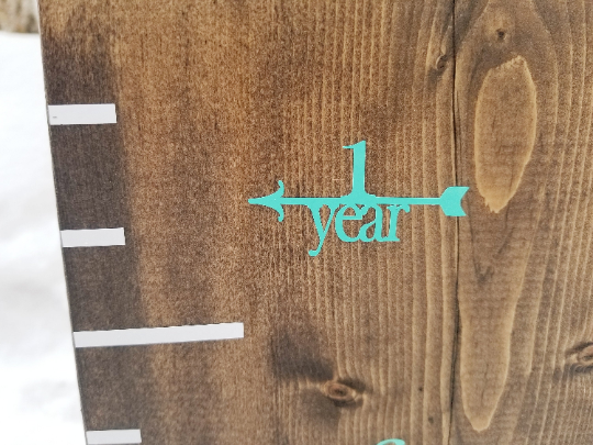 A wooden growth chart with Fancy Height Marking Arrows by Little Prairie Craft Co.