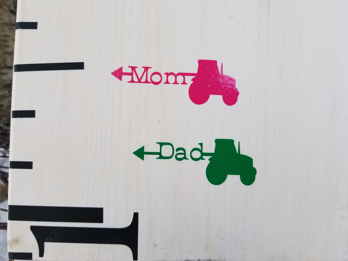 A Mom or Dad Tractor Arrows wooden ruler with the brand name Little Prairie Craft Co. on it.