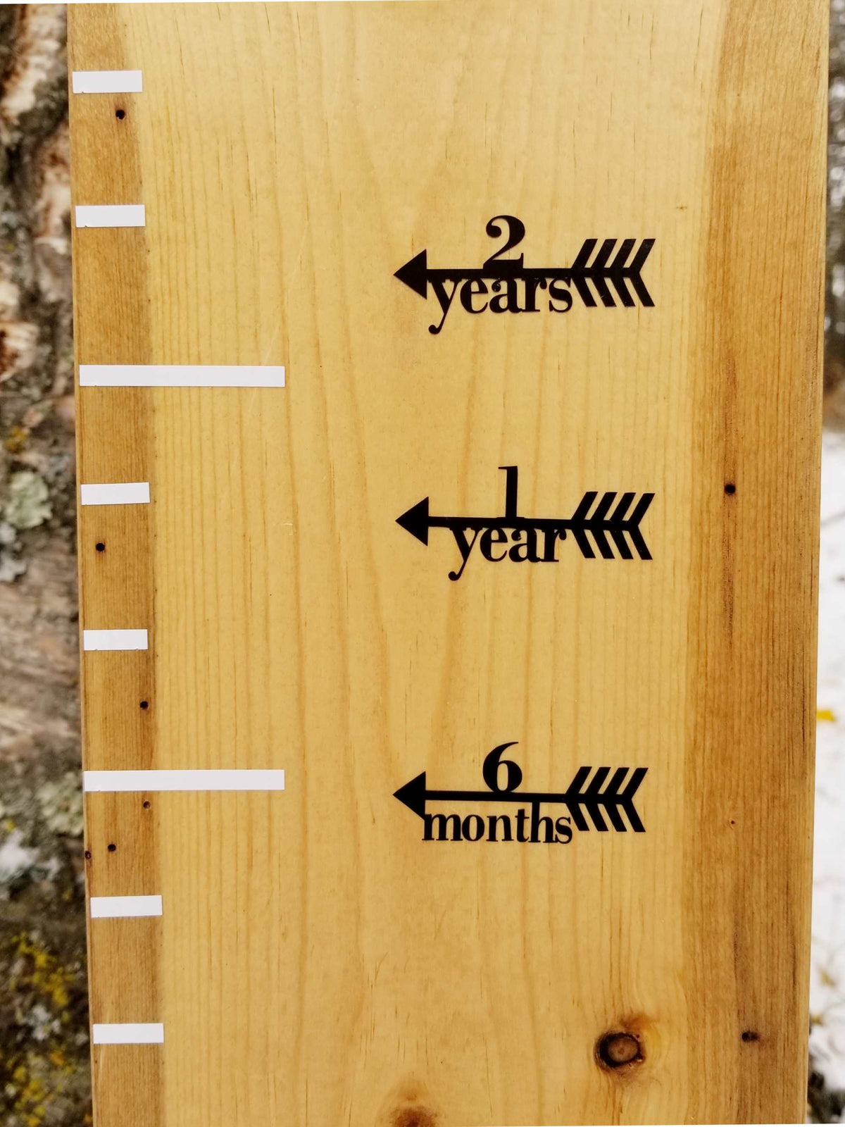 A Little Prairie Craft Co. wooden growth chart with Classic Height Marking Arrows on it.