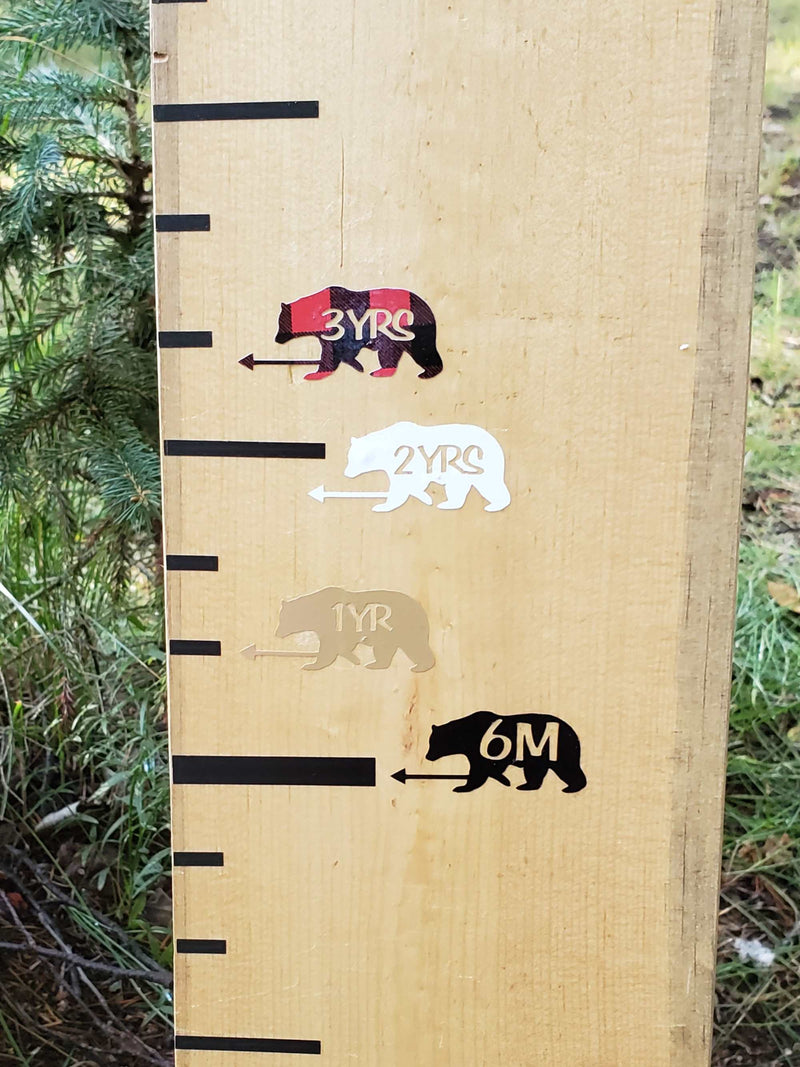A wooden growth chart with Little Prairie Craft Co. Bear Height Marking Arrows on it.