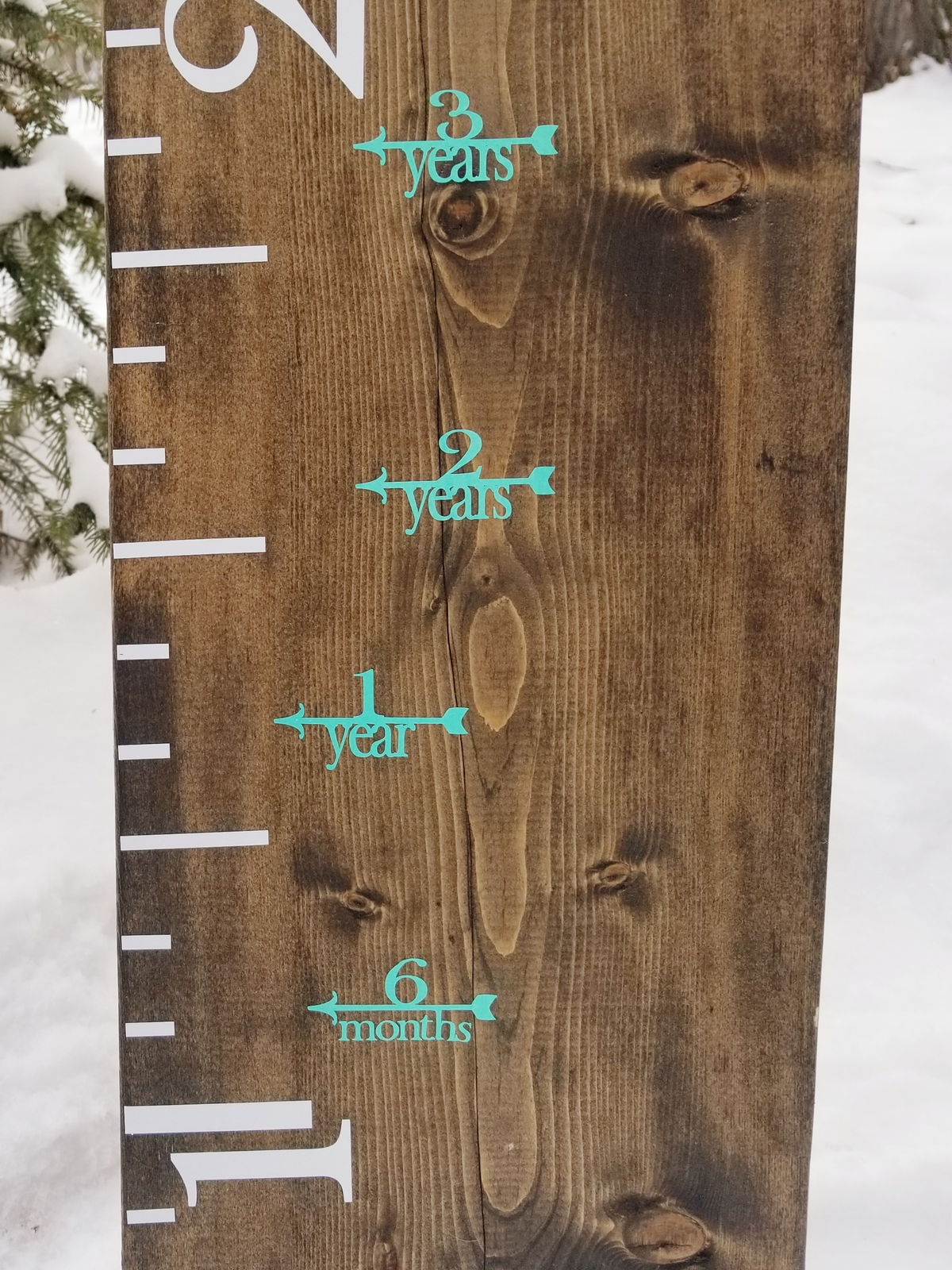 A Fancy Height Marking Arrows growth chart in the snow by Little Prairie Craft Co.