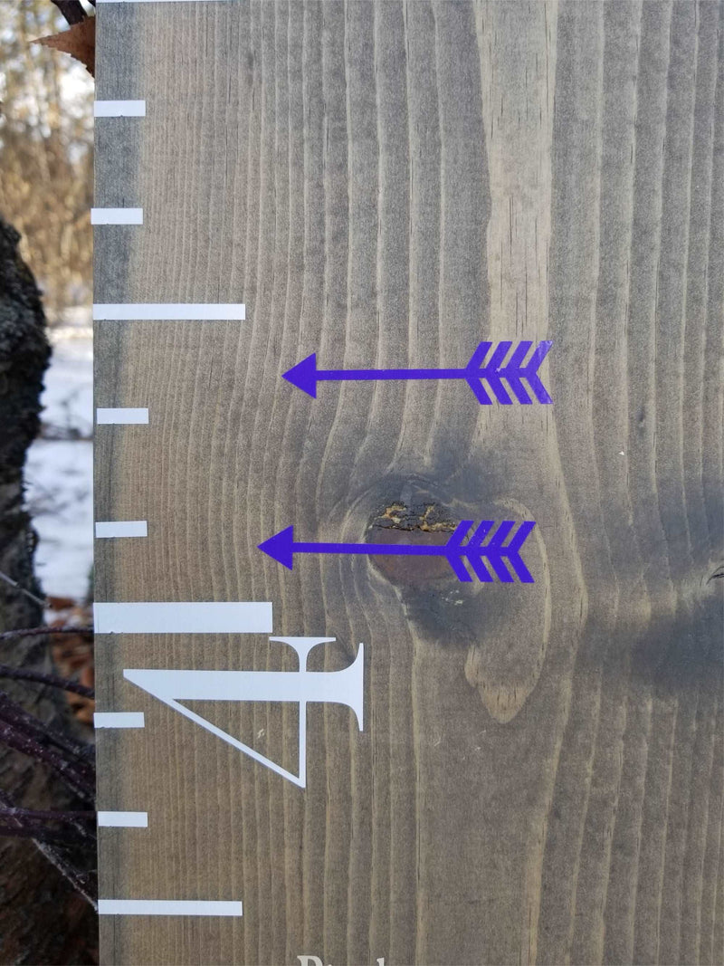 A wooden growth chart with Classic Blank Height Marking Arrows from Little Prairie Craft Co. on it.