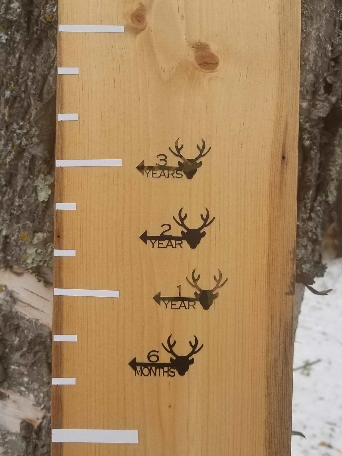 A wooden growth chart with Deer Height Marking Arrows by Little Prairie Craft Co.