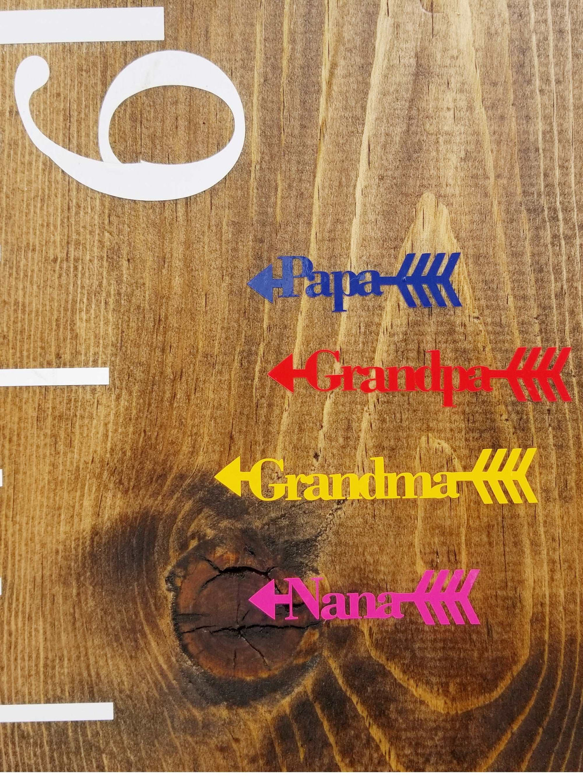 Arrows on a wooden board with the words grandpa and grandma have been replaced with Classic/Traditional Family Height Markers from Little Prairie Craft Co.