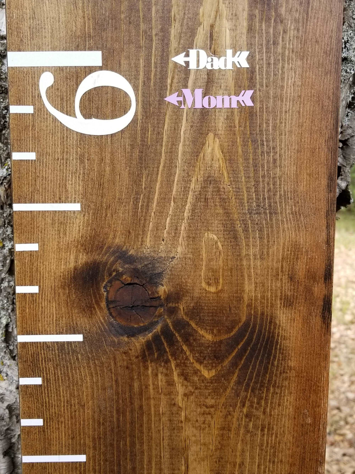 A Little Prairie Craft Co. wooden growth chart with the words 'baby' and 'mom', featuring Chunky Skinny Parent Height Markers.