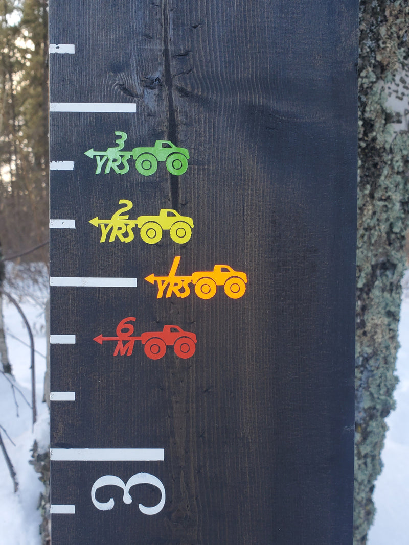 A Little Prairie Craft Co. wooden growth chart with Monster Truck Height Marking Arrows on it.