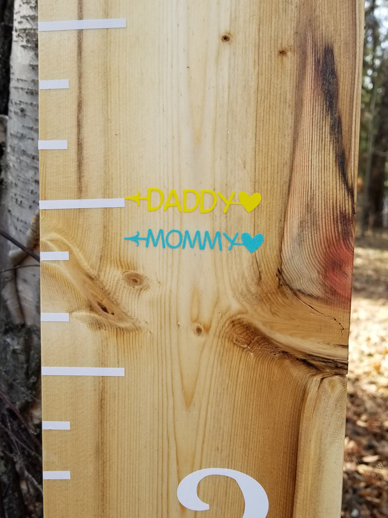 A Little Prairie Craft Co. wooden growth chart with the words daddy and mommy using Parent Skinny Heart Height Markers.