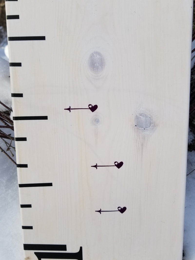 A wooden Lil Mini Hearts Height Marking Arrows growth chart by Little Prairie Craft Co.