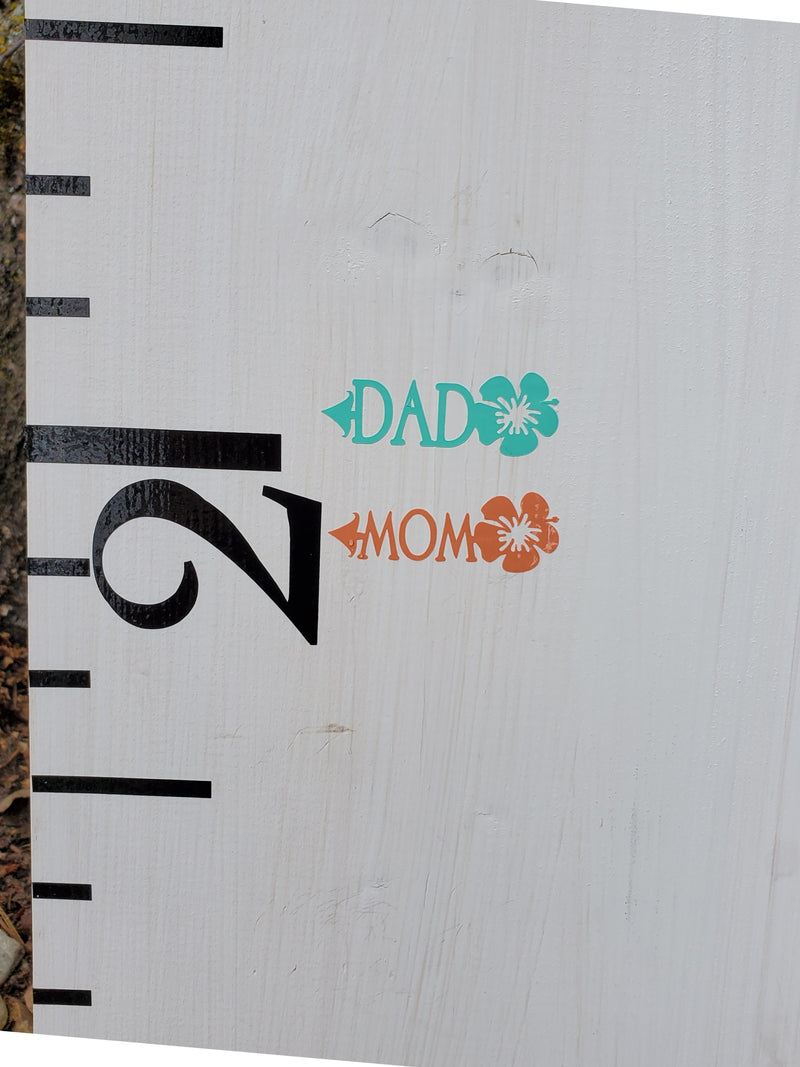 A Hibiscus Parent Height Markers ruler with the words dad and mom on it, made by Little Prairie Craft Co.
