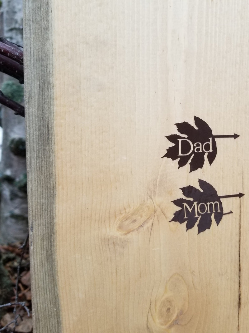 A piece of wood with the words dad and mom on it, called Leaf Parent Height Markers by Little Prairie Craft Co.